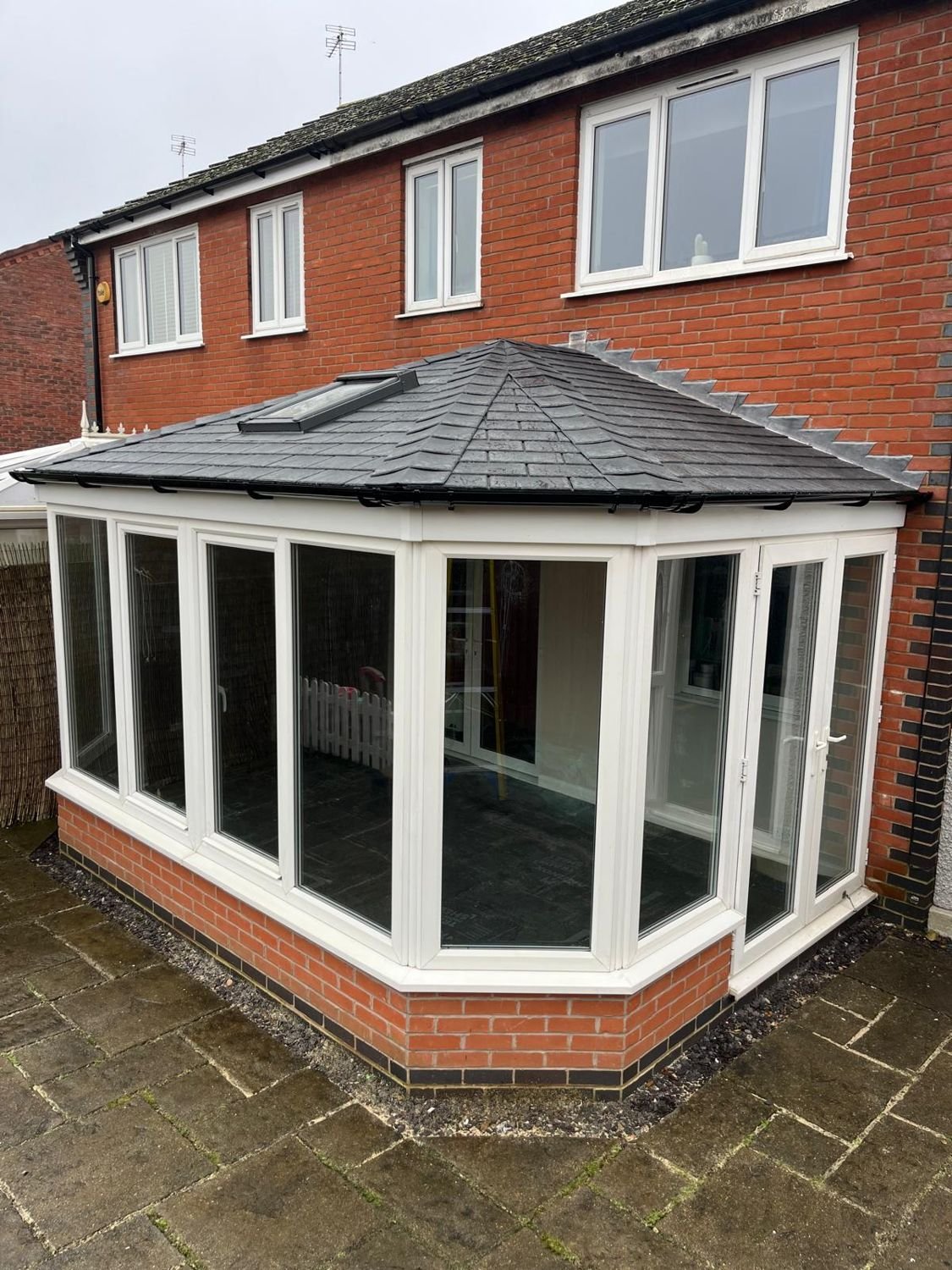 After: white-framed conservatory, glass roof replaced with a tiled warm roof