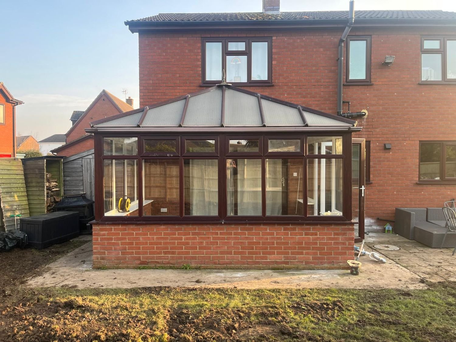 Before: mahogany-framed conservatory, glass roof replaced by a tiled roof