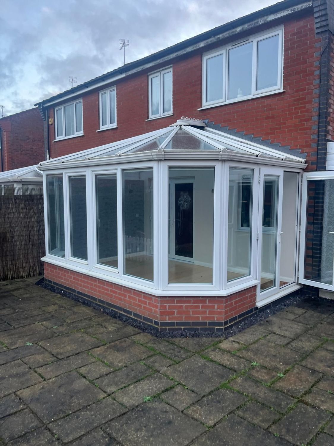 Before: white-framed conservatory, glass roof replaced with a tiled warm roof