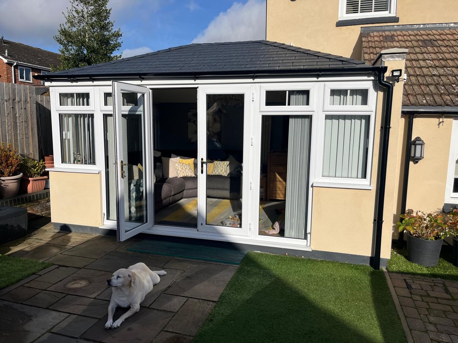 Conservatory with a dark tiled roof
